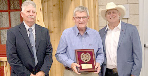 Hallettsville Tribune-Herald staff writer Jimmy Appelt was presented the first place Friends of Conservation award at the Area III Conservation Awards Banquet held Tuesday, May 6 at the Anne Thomas Friar Homemaking Building in Cuero. From left are Leroy Wolff, vice-president of the Association of Texas Soil and Water Conservation Districts, Appelt, and Jose Dodier, a member of the Texas State Soil and Water Conservation Board. Photo by Dennis Evins