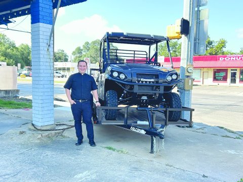 Father Jacob Mendoza is shown with the first place raffle prize, a 2026 Kawasaki Mule Pro FXT 1000LE, which will be given away at the Shiner Catholic Church Fall Picnic slated for Sunday, August 31. This mule includes a Falcon 14 ft. single axle trailer, generously donated by Boehm Tractor Sales. If you would like to purchase a ticket, please call the church office or visit the church’s website, www.sscmshiner.org. Photo by Clayton Kelley.