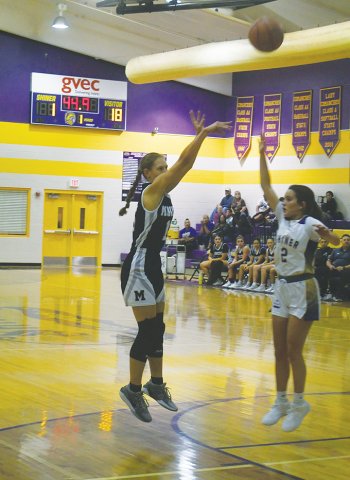 Ava Olivarez takes an inside shot with Shiner’s Emersyn Boehm defending. Olivarez scored six points. Photo by Mark Lube.