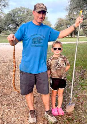 Not all heroes wear capes… some carry a shovel. The Bippert family marks copperhead number nine in Lavaca County while his princess proudly (and safely) looks on. Photo submitted by Tracie Bippert