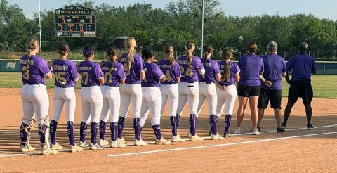 The Shiner Junior softball players and coaches/managers stand for the national anthem. Photo courtesy of Amanda Ulcak.
