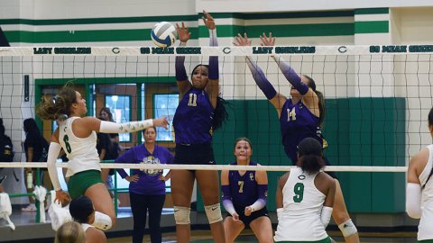 Kiera Curtis (#11) and Kayden Smith (#14) leap up to block a hit from Cuero’s Taylor Gayle Thursday morning in the Cuero Tournament. Shiner won five of eight games and placed third in the tournament. Photo by Mark Lube.