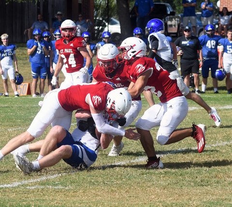 St. Paul defenders bring down a Falcon ball carrier on Friday. Photo by Mark Lube.