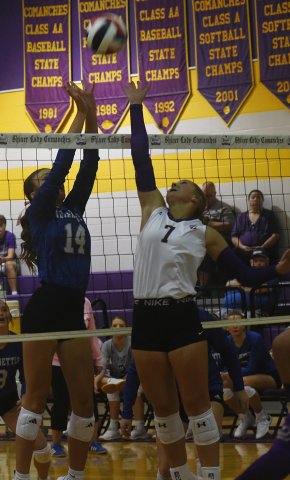 Taylor Kocian jousts at the net with Indianette Adley Zappe Aug. 18 in the match at Shiner. Kocian made three kills. Photo by Mark Lube.