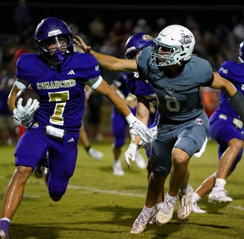 Comanche running back Clayton Fric (left) turns downs the ‘greeting’ by Industrial’s Nate Chaney during Friday’s night game at Comanche Stadium. Fric led the Shiner rushing attack with 74 yards and two touchdowns. Photo courtesy of Photos by Lori Raabe.