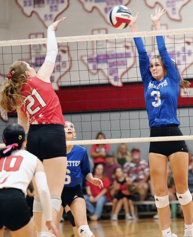 Addy Matias puts up a kill attempt while Sacred Heart’s Layne Besetzny tries to block it Thursday at St. Paul High School in the Lady Cards 3-0 win. Photo by Chuck Grafe/Hallettsville Tribune-Herald.