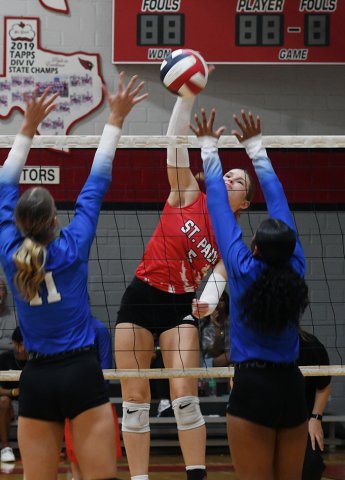 Skylar Mozisek tries put a ball past a pair of Edna players in the second game of St. Paul’s three-set win over the Cowgirls Sept. 1. Photo by Mark Lube.