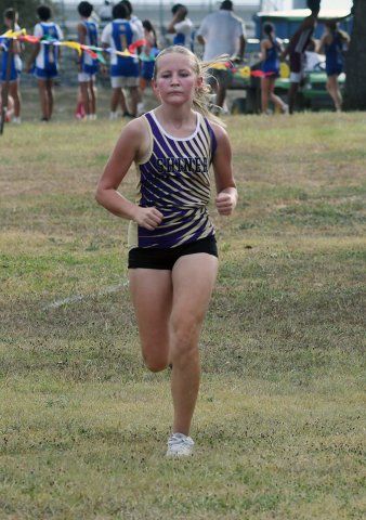Alaina Sofka races down the hill towards the finish line. She had a time of 16:10.49 for a top 15 finish in the varsity girls 1A-2A division. Photo by Mark Lube.