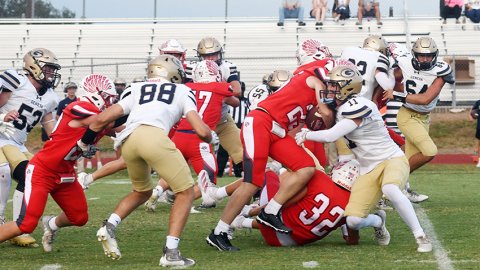 Carter Chilek fights to break break free of Geneva Boerne’s Sam Horton during the first half. Photo by Mark Lube.