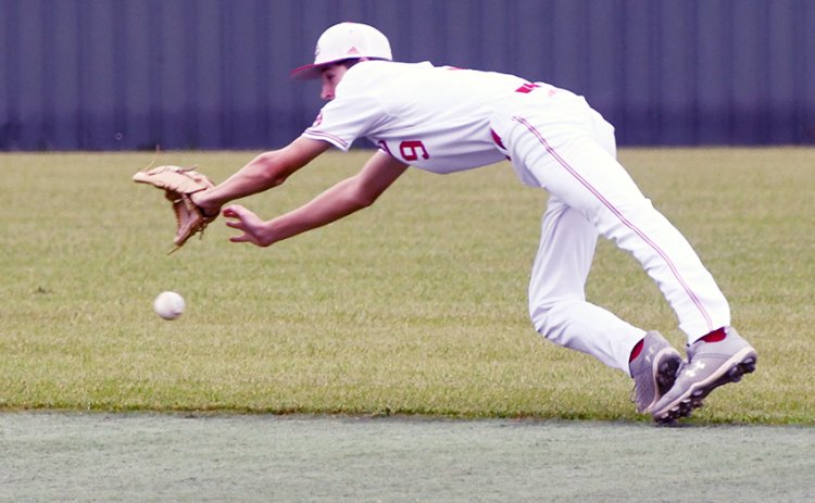 Cardinal second baseman Cody Malinovsky makes an acorbatic dive for this slightly-above-the-ground ball April 23 against Bryan St. Joseph in the bi-district round. St. Paul won the game 2-0. Photo by Mark Lube.