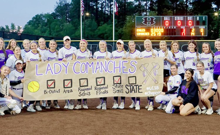The Shiner softball team poses for a photo with their custom-made banner after defeating Como-Pickton 17-3 in game three of the state semifinals-series. Shiner plays Sundown Thursday (May 28) at 1 p.m. in the Class 2ADII state final. Photo courtesy of Louann Heinsohn.